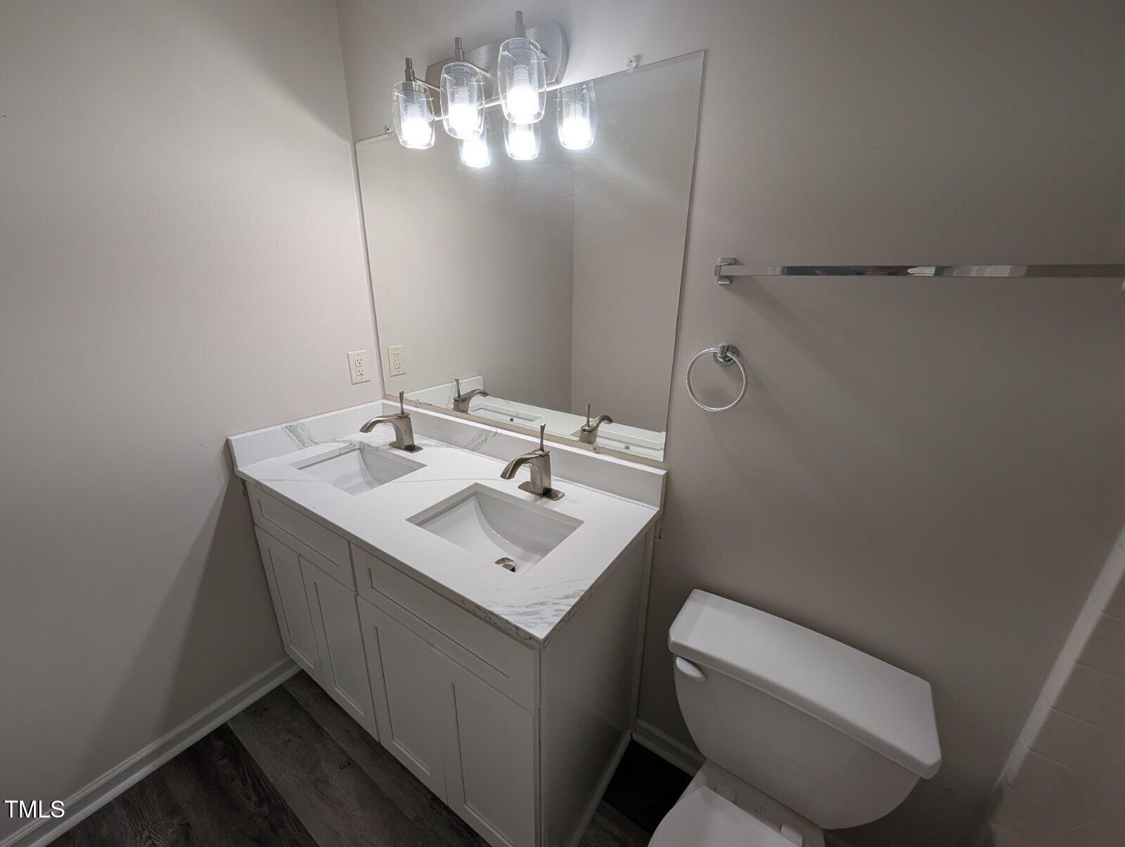 7528 Argent Valley Drive Raleigh, NC 27616 - Photo 37 of 47 a bathroom with a toilet sink and mirror