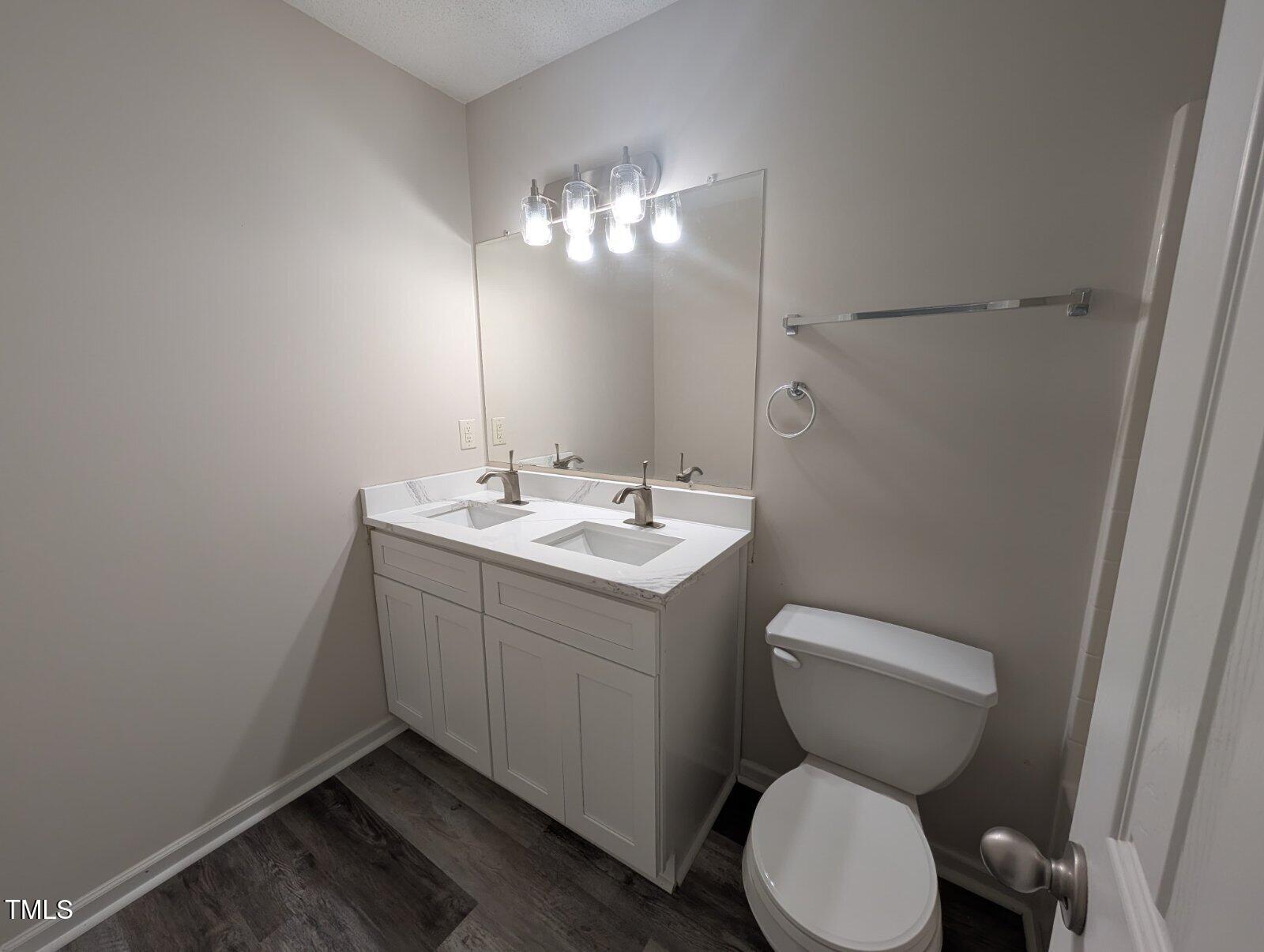 7528 Argent Valley Drive Raleigh, NC 27616 - Photo 38 of 47 a bathroom with a toilet sink and mirror