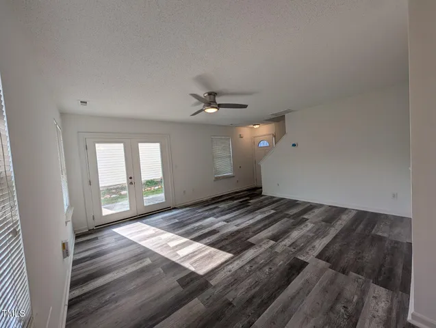 a view of a livingroom with a ceiling fan and window