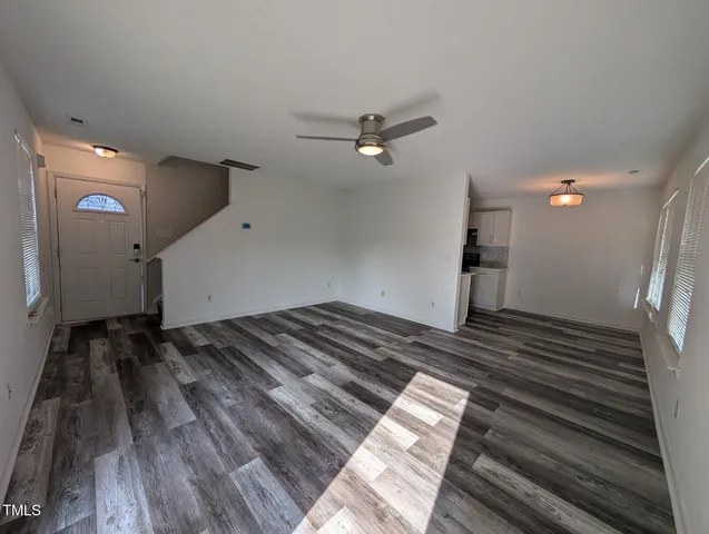 a view of an empty room and wooden floor