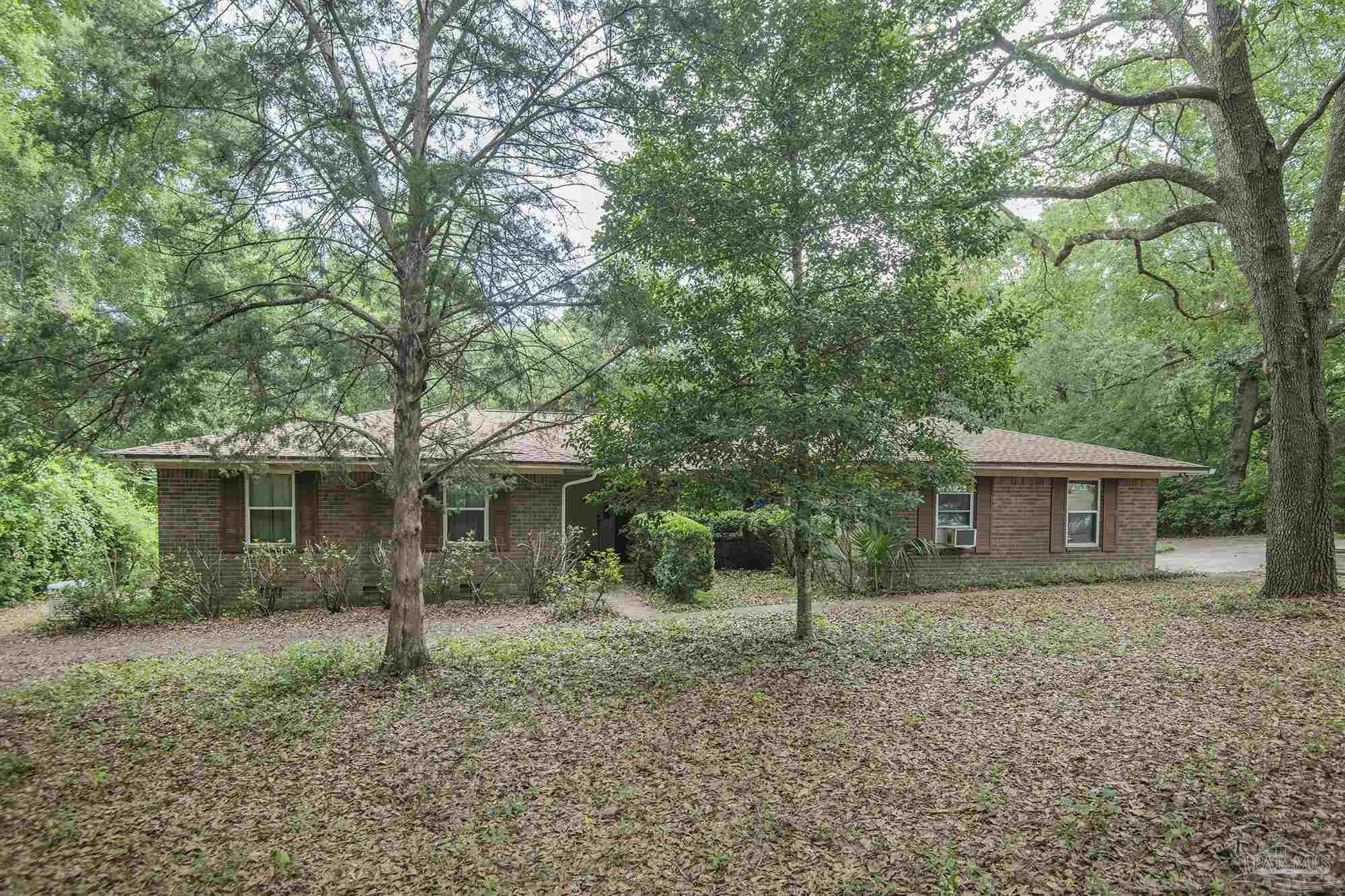 1210 Goldenrod Road Cantonment, FL 32533 - Photo 1 of 50 front view of a house with a yard