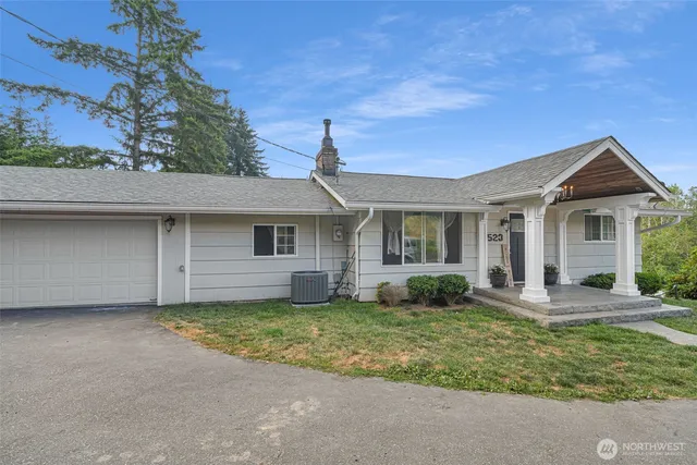 a front view of a house with a garden and porch
