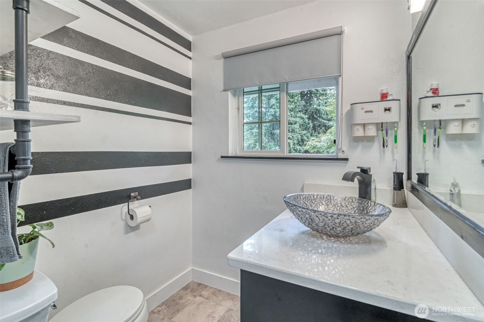 523 Haywire Road Winlock, WA 98596 - Photo 19 of 40 a bathroom with a granite countertop sink a toilet a mirror and shower