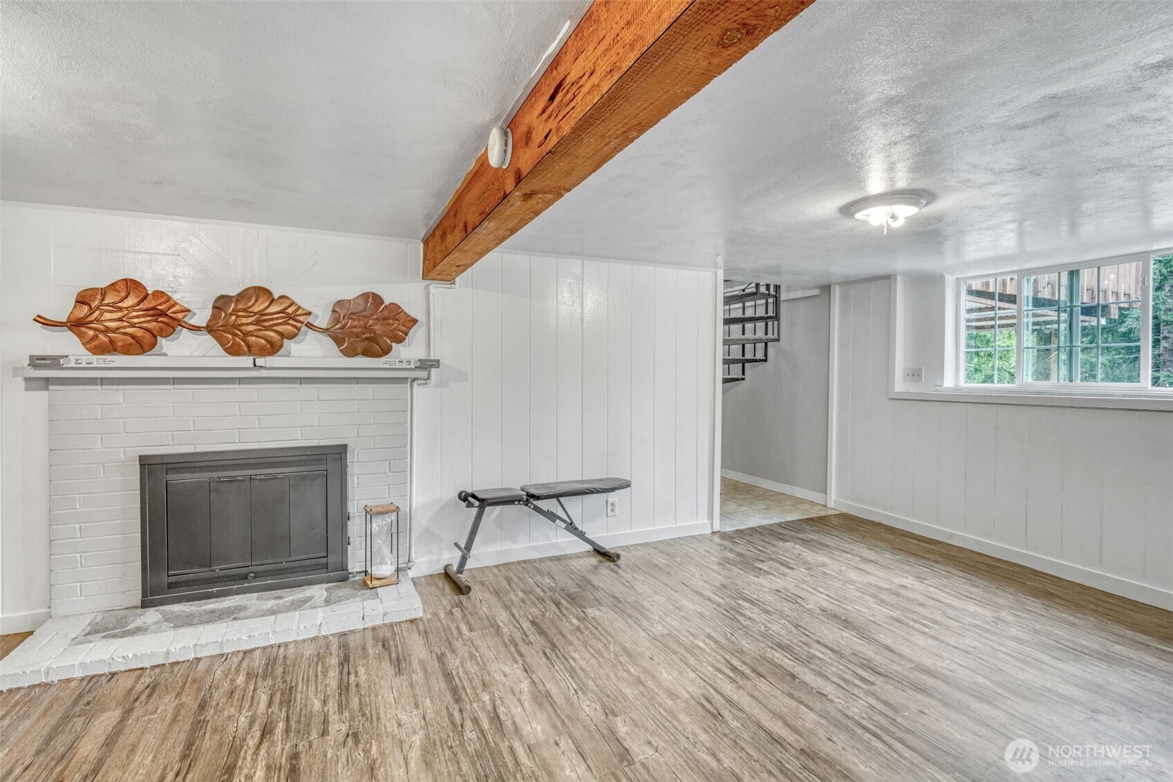 523 Haywire Road Winlock, WA 98596 - Photo 24 of 40 a view of an empty room with wooden floor fireplace and a window
