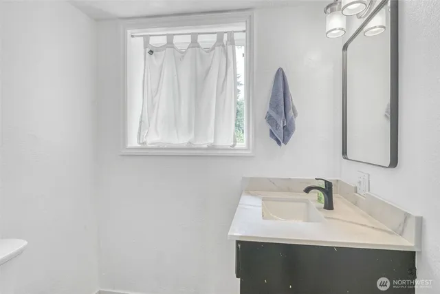 a view of a kitchen with a sink and a window