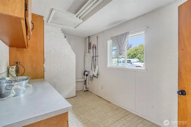 a utility room with stainless steel appliances washer and dryer