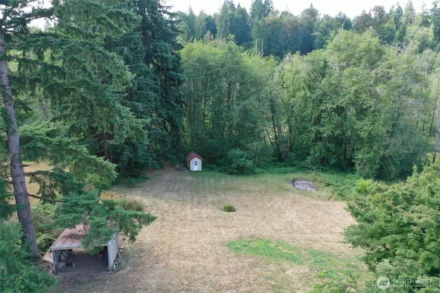 an aerial view of a house with a yard basket ball court and outdoor seating