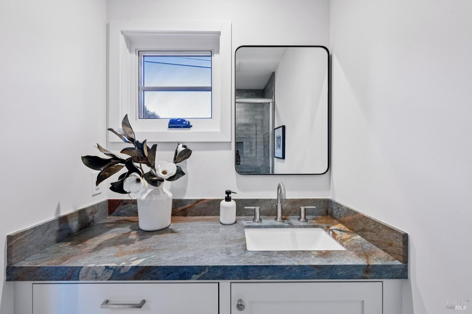 185 Elm Road Bolinas, CA 94924 - Photo 25 of 43 a bathroom with a granite countertop sink and a mirror