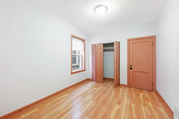 a view of a room with wooden floor and window