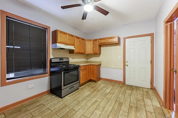 a kitchen with stainless steel appliances granite countertop a stove a sink and a refrigerator