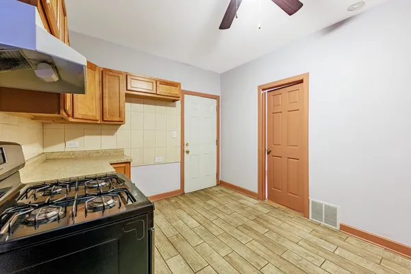 a kitchen with stainless steel appliances granite countertop a stove and a refrigerator