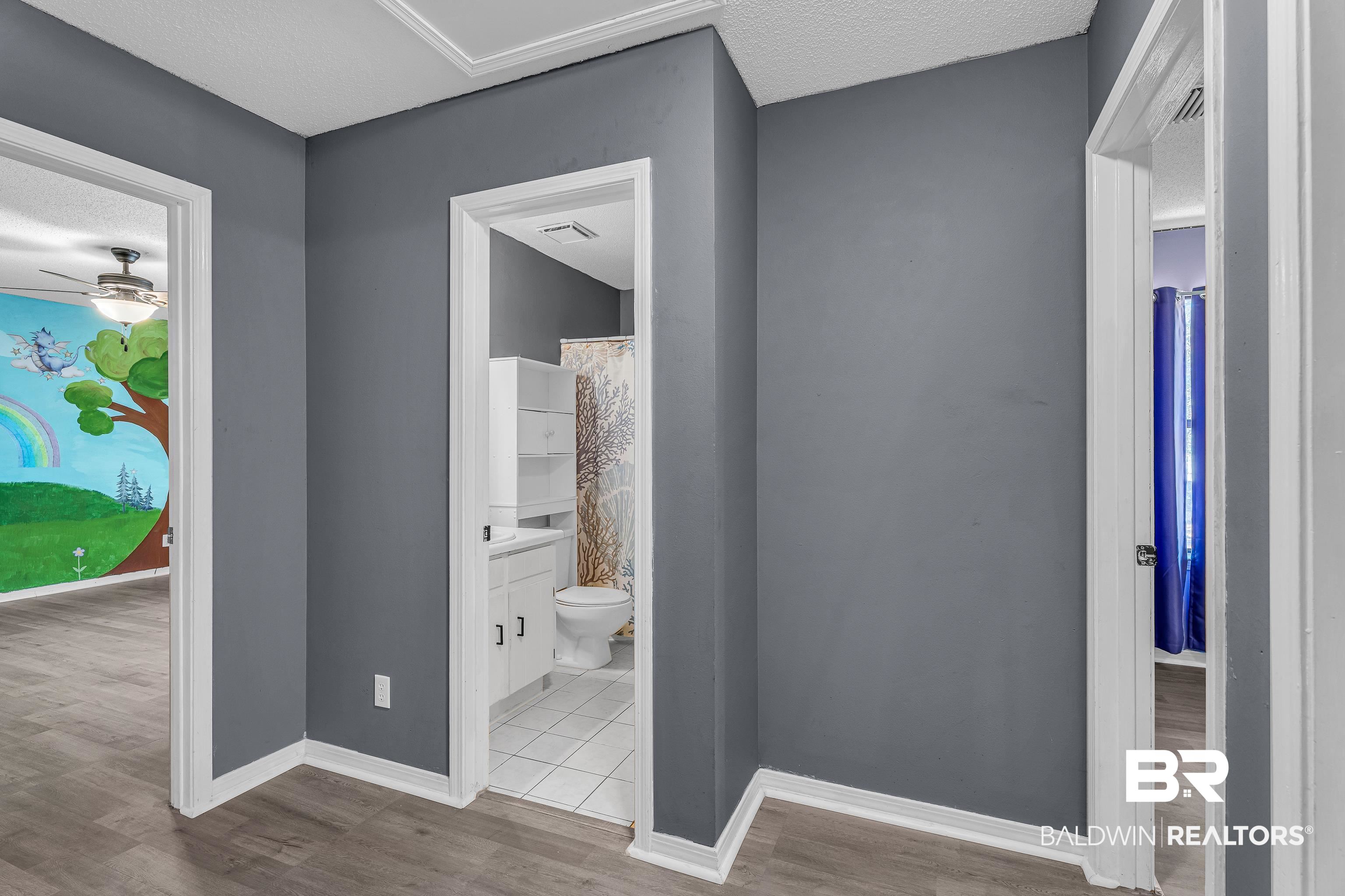 6135 Oak Cliff Drive Eight Mile, AL 36613 - Photo 24 of 30 Hallway featuring light wood finished floors and a textured ceiling