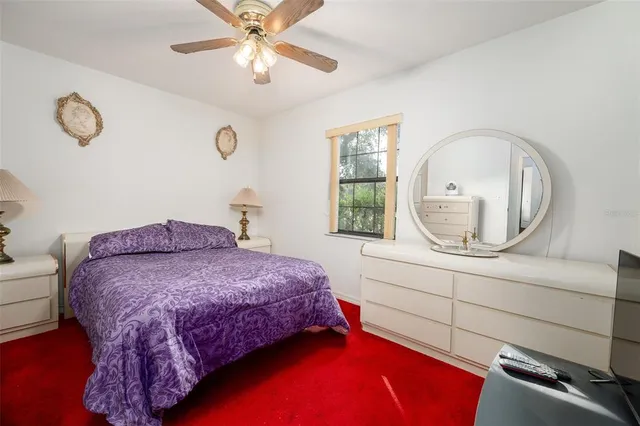 a bedroom with a bed a mirror and a window