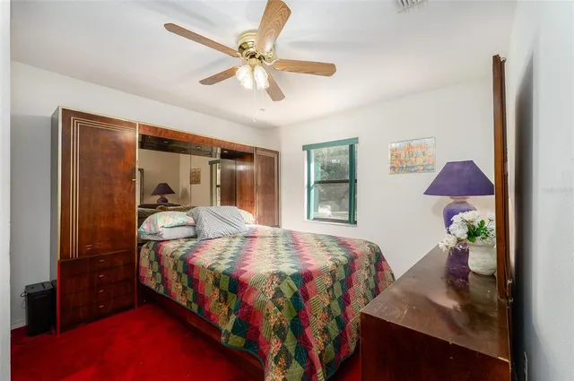 a bedroom with a bed and dresser with mirror