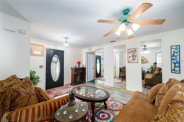 a living room with furniture and a chandelier