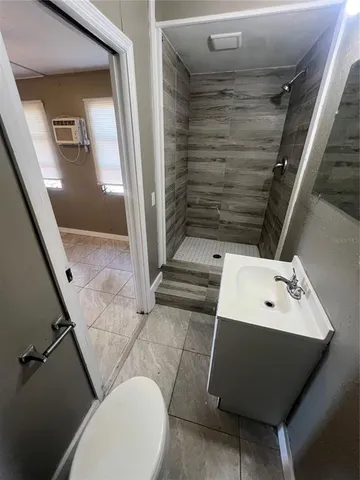 a bathroom with a toilet a sink and mirror