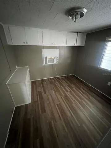 a view of storage and utility room with wooden floor