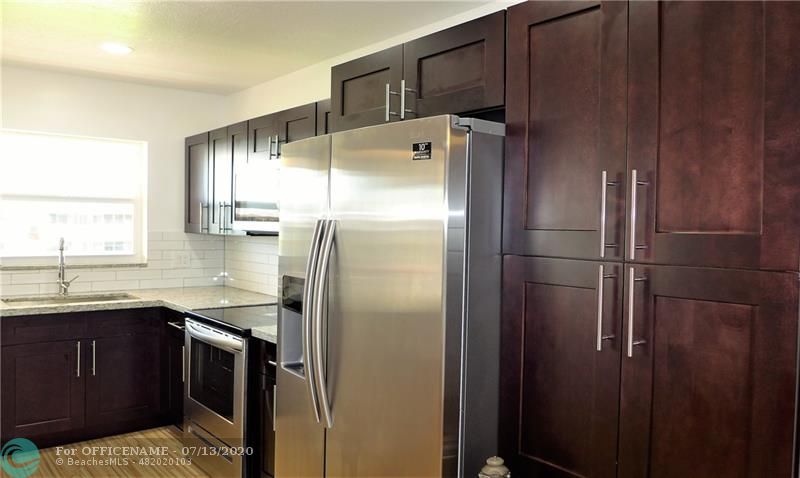 a kitchen with stainless steel appliances a refrigerator and sink