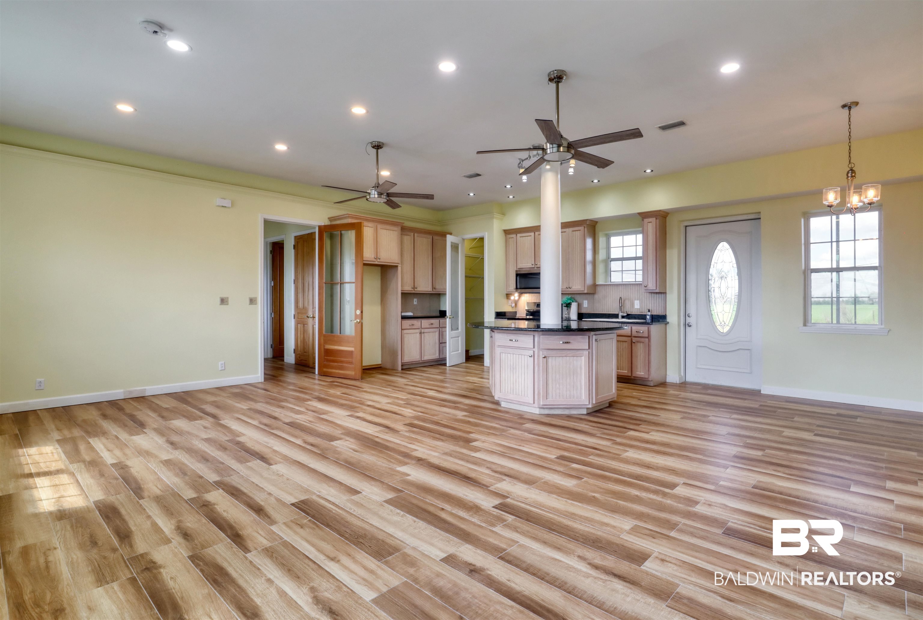 28461 Gardner Road Elberta, AL 36530 - Photo 45 of 46 Kitchen featuring open floor plan, dark countertops, a center island, and light wood finished floors
