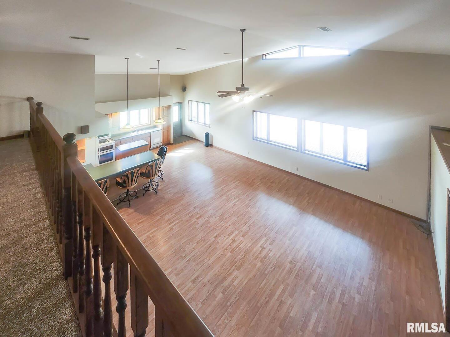 2878 Sunfield Road Du Quoin, IL 62832 - Photo 35 of 47 a kitchen with kitchen island a wooden floor and a refrigerator