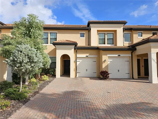 a view of a house with a yard and tree s