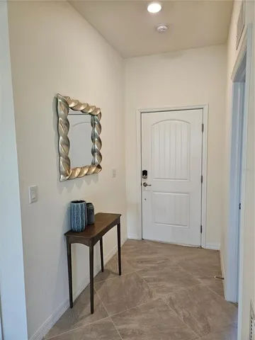 a living room with stainless steel appliances furniture and a kitchen view
