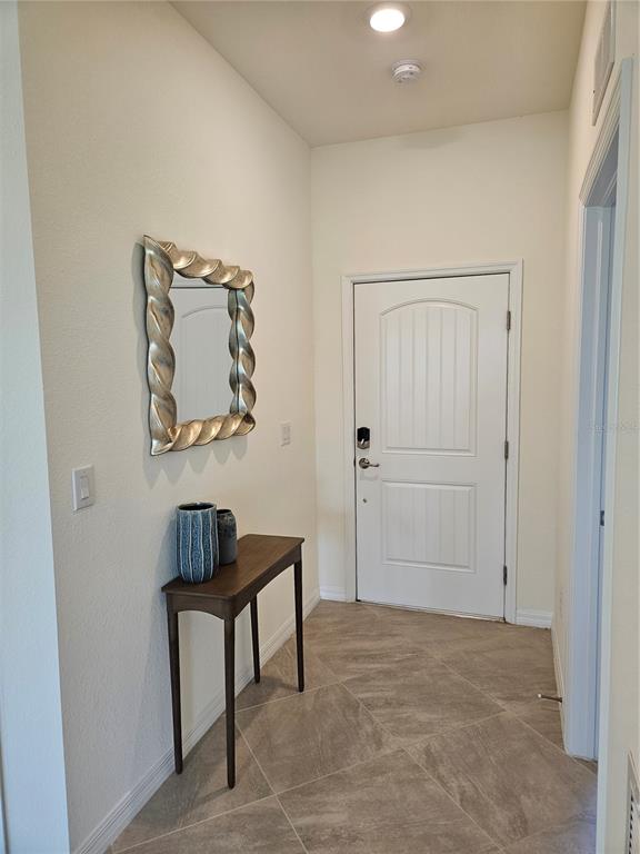 10039 Crooked Creek Drive, Unit 102 Venice, FL 34293 - Photo 13 of 36 a view of room with workspace and mirror