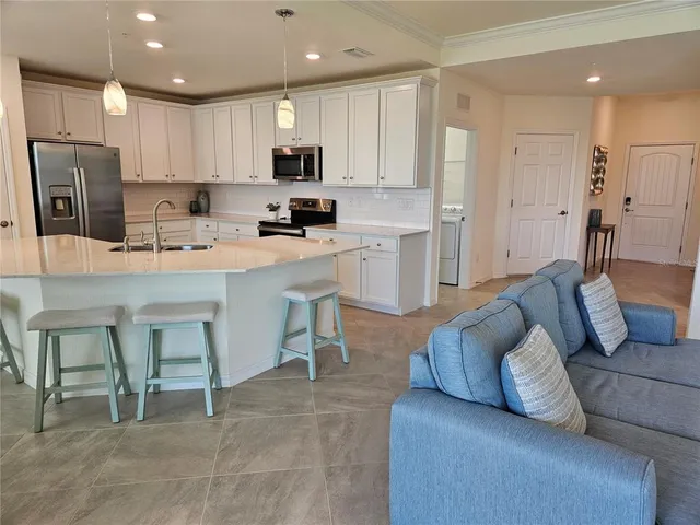 a kitchen with refrigerator cabinets and wooden floor