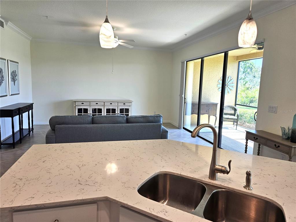 10039 Crooked Creek Drive, Unit 102 Venice, FL 34293 - Photo 18 of 36 a kitchen with a table chairs and a window