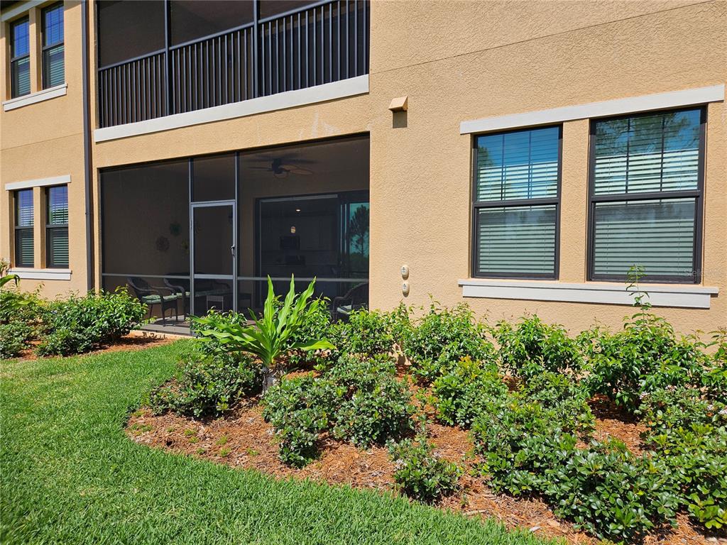 10039 Crooked Creek Drive, Unit 102 Venice, FL 34293 - Photo 21 of 36 front view of a house with a yard