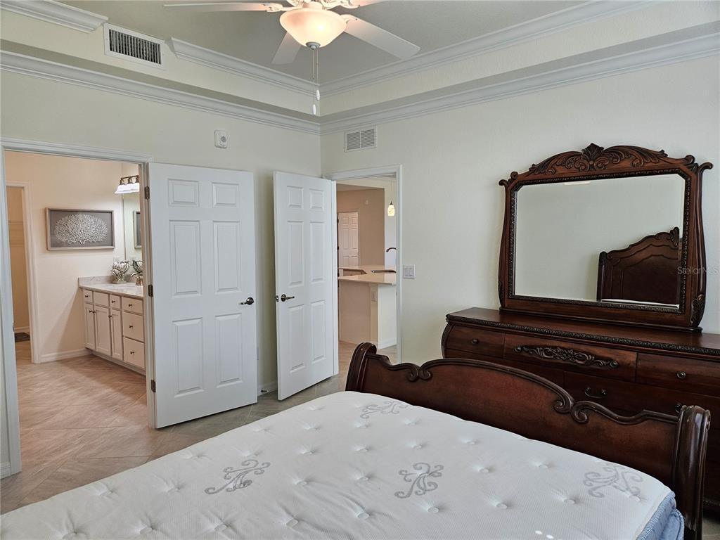 10039 Crooked Creek Drive, Unit 102 Venice, FL 34293 - Photo 27 of 36 a living room with a bed and a dresser