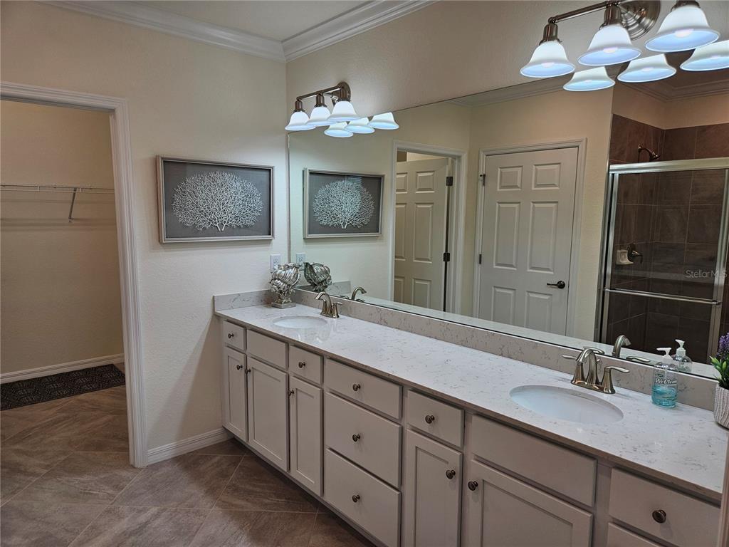10039 Crooked Creek Drive, Unit 102 Venice, FL 34293 - Photo 28 of 36 a bathroom with a double vanity sink and a mirror