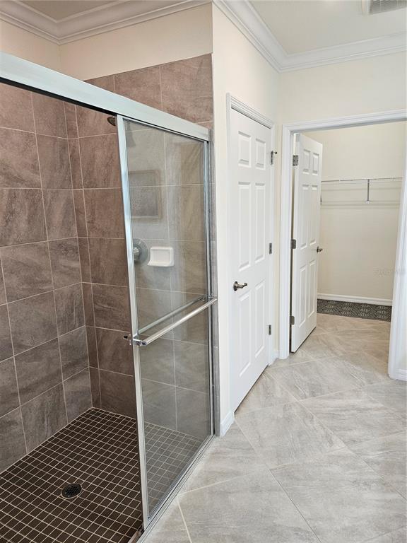 10039 Crooked Creek Drive, Unit 102 Venice, FL 34293 - Photo 29 of 36 a bathroom with a glass shower door