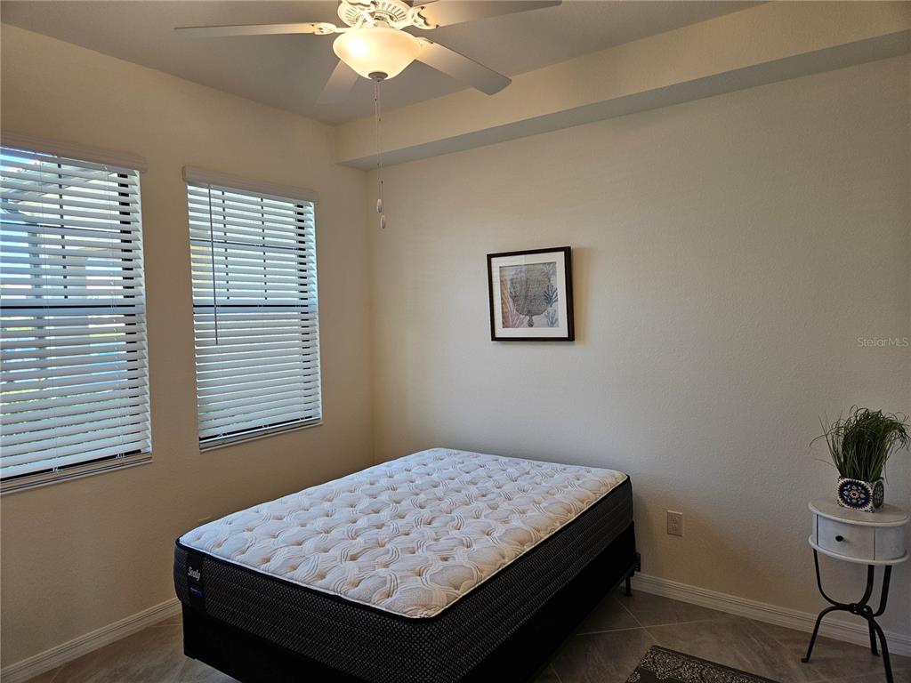 10039 Crooked Creek Drive, Unit 102 Venice, FL 34293 - Photo 32 of 36 a bedroom with a bed and a window