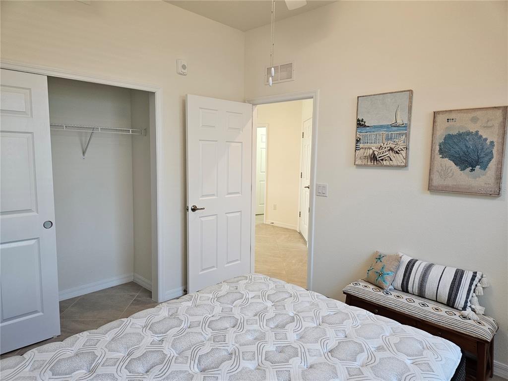 10039 Crooked Creek Drive, Unit 102 Venice, FL 34293 - Photo 33 of 36 a bedroom with a bed and a couch