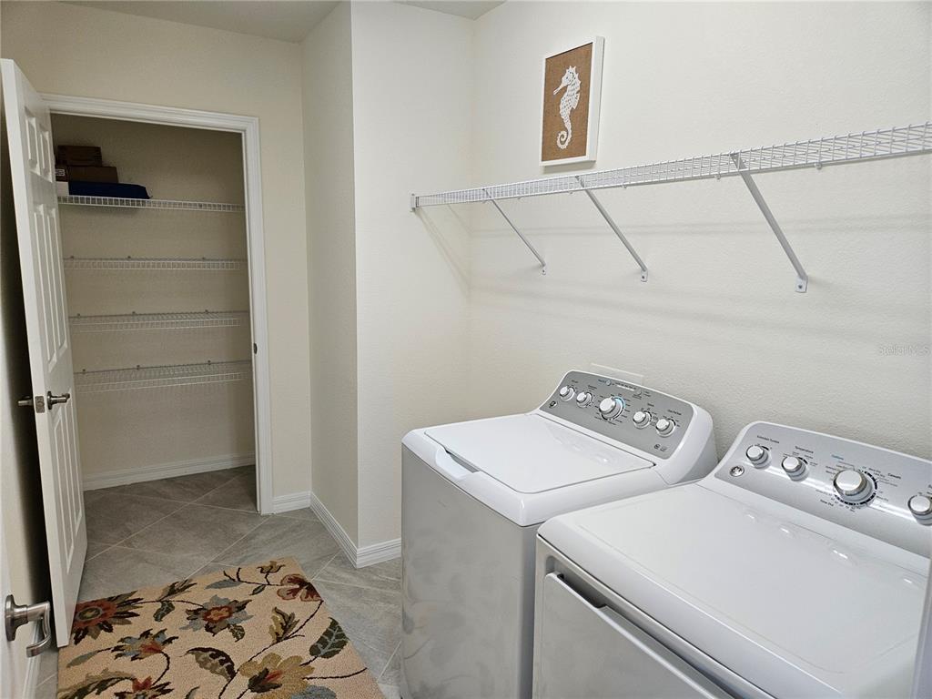 10039 Crooked Creek Drive, Unit 102 Venice, FL 34293 - Photo 35 of 36 a utility room with dryer and washer