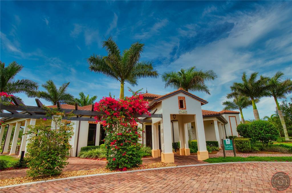 10039 Crooked Creek Drive, Unit 102 Venice, FL 34293 - Photo 7 of 36 a front view of a house with a garden