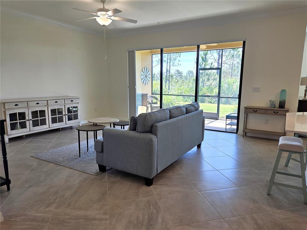10039 Crooked Creek Drive, Unit 102 Venice, FL 34293 - Photo 10 of 36 a living room with furniture and a large window