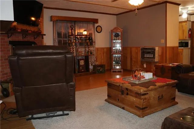 a living room with furniture flat screen tv and lamp