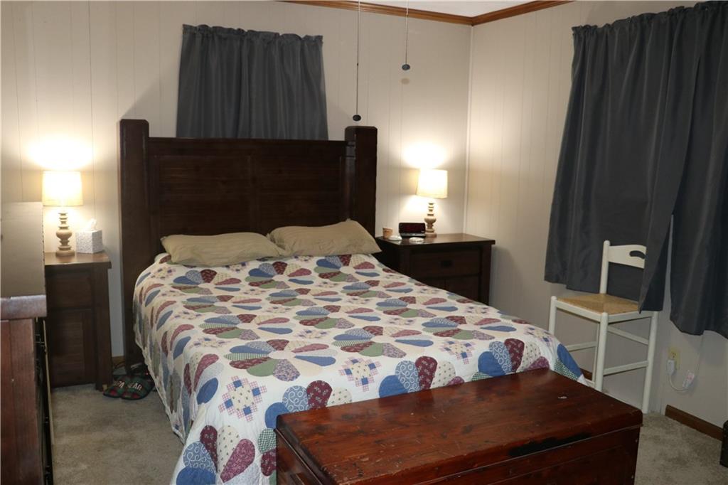 463 Compton Road Silver Creek, GA 30173 - Photo 5 of 12 a bedroom with a bed and wooden floor