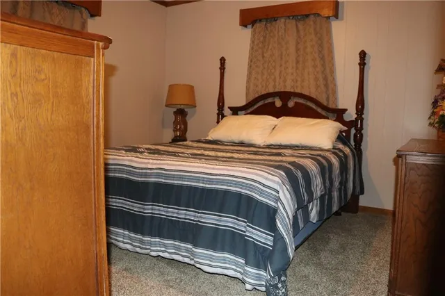 a bedroom with a bed and a cabinet