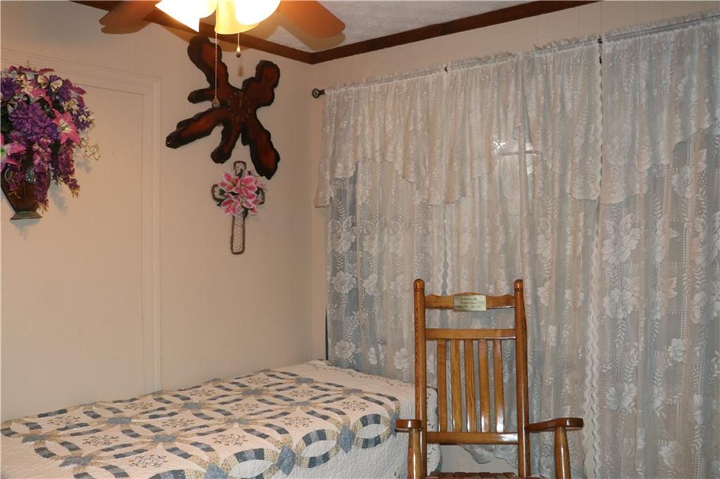 463 Compton Road Silver Creek, GA 30173 - Photo 8 of 12 a bedroom with a bed and a chandelier