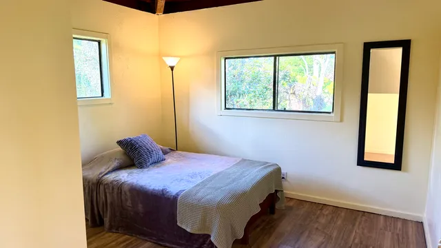 a bedroom with a bed and a window