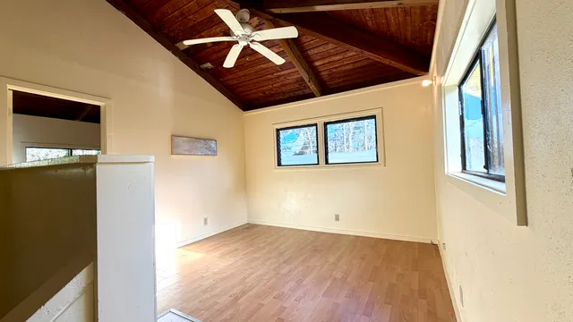 a living room with a bed and a window