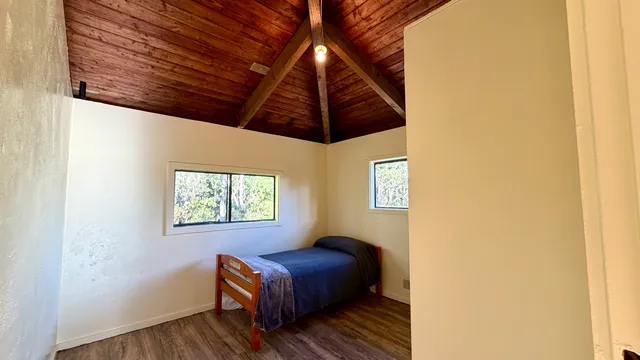 a view of room with wooden floor and windows