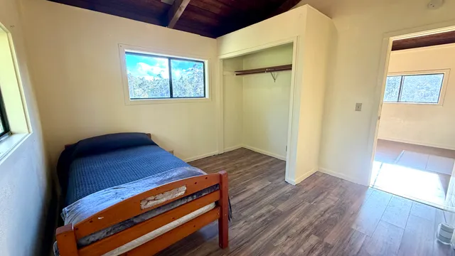 a view of a room with wooden floor and windows