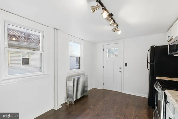 a view of a room with wooden floor and ceiling fan