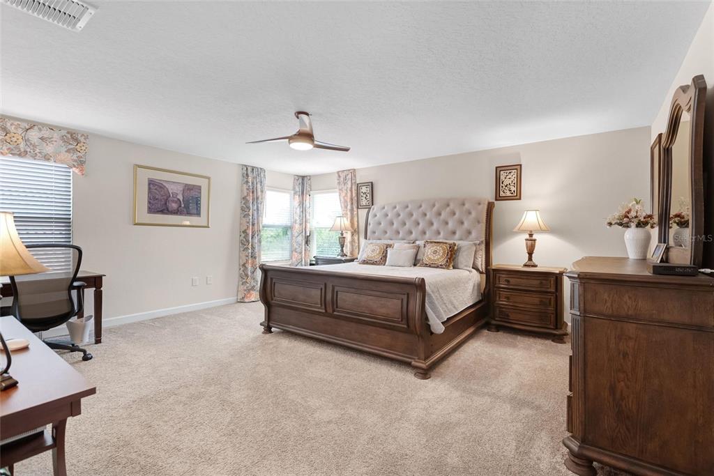 1089 Blackwolf Run Road Davenport, FL 33896 - Photo 37 of 82 a spacious bedroom with a bed and a desk