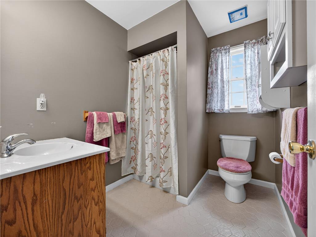 853 Lahr Road Nazareth, PA 18064 - Photo 18 of 29 A compact full bathroom featuring a white vanity with a single sink and a bathtub/shower combination.