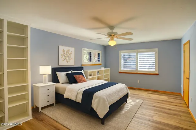 a bedroom with a large bed and a window